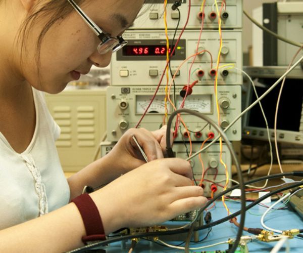 Communications Engineering student working in a lab.