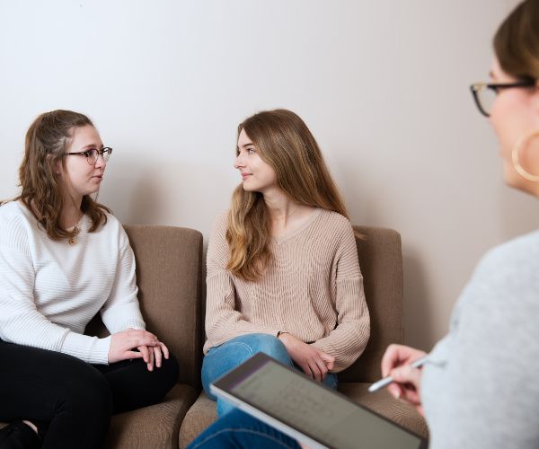 Social Work students conduct a mock counselling session in the School of Social Work’s observation room.