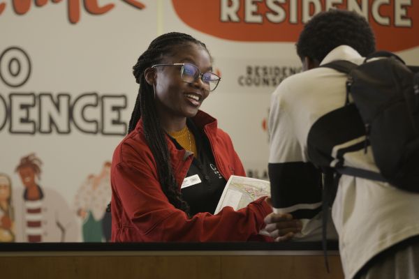Residence Desk employee assisting a student.