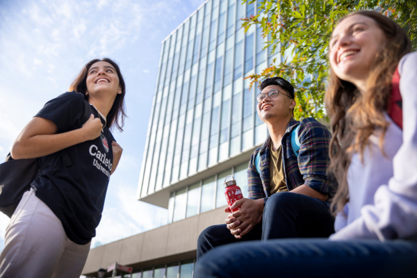 International Students looking in the sky. Sprott Business School in the background