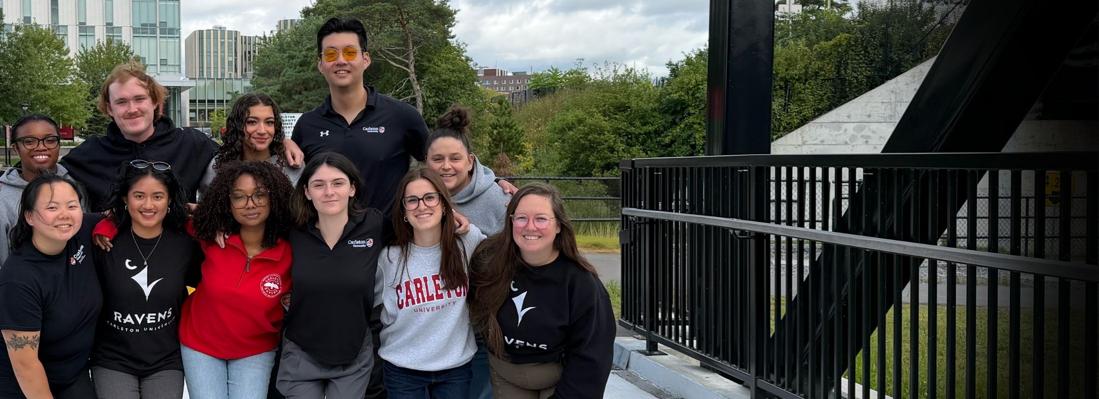 Carleton University recruitment team on the pedestrian bridge on the Carleton campus.
