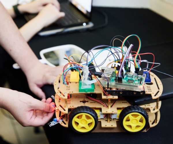 Students wiring a small vehicle.