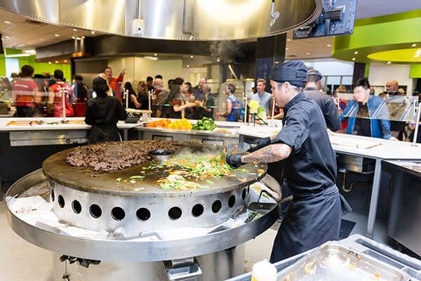 A chef cooks in the newly renovated dining hall in Residence Commons.