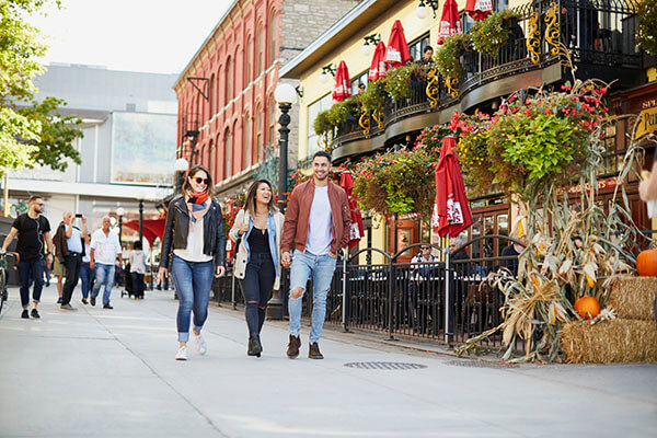 Three people walk in the Byward Market in downtown Ottawa.