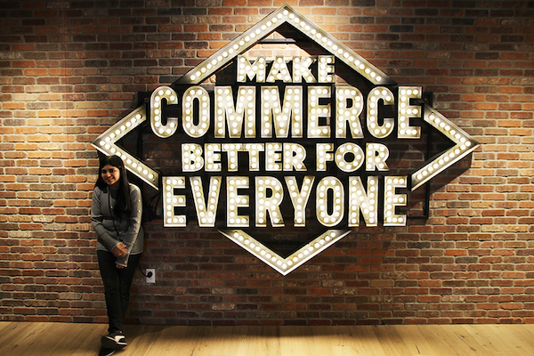 Ketki in front of Shopify sign Make Commerce Better for Everyone
