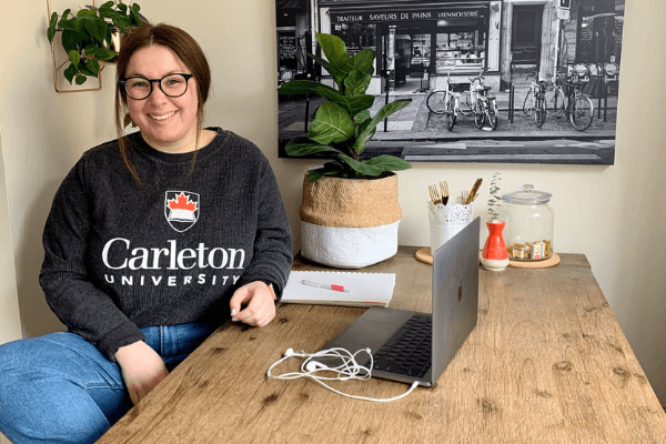 Carleton representative at a desk with a laptop.