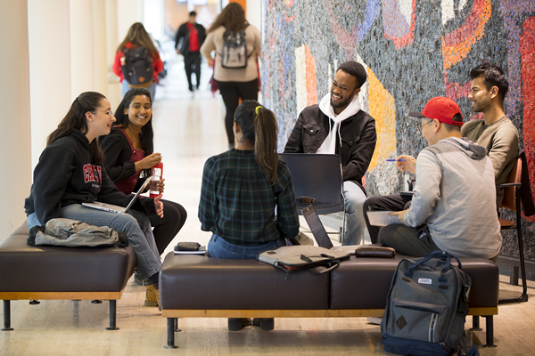 Students sitting in the Tory Building lobby.