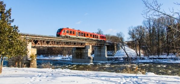 O train going over the bridge on the Rideau River, snow on the ground, on campus