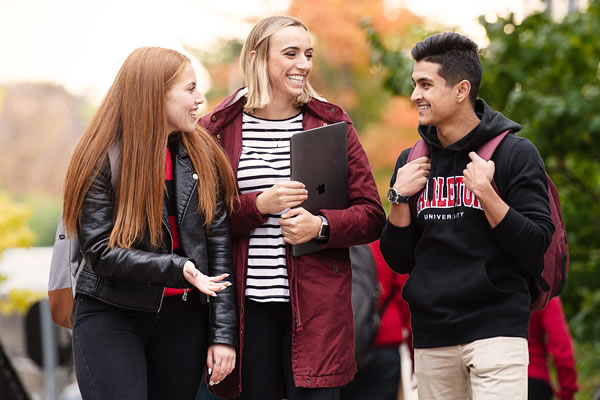 Students walking and talking on campus