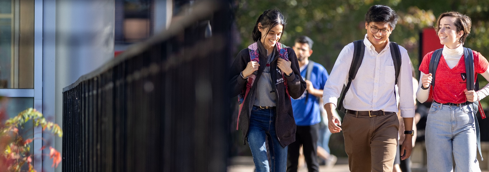 Three students walking in the Academic Quad.