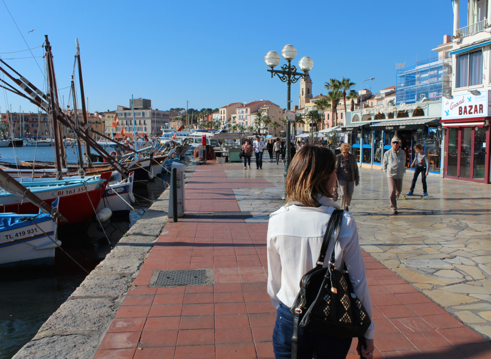 A girl walks along the boardwalk in Bandol sur Mer, France.