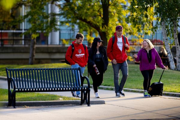 Four students walking together in the Academic Quad.