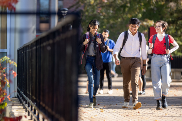 Three students walking in the Academic Quad.